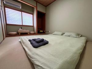 Postel nebo postele na pokoji v ubytování 青の居 直达Usj 直达港区海游馆 可停车