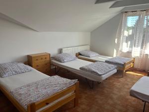 a group of four beds in a room at Jabłoń w Ogrodzie in Częstochowa