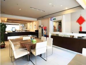 a dining room with a table and white chairs at JinJiang Inn Nanjing The Confucius Temple Zhonghuamen Metro Station in Nanjing