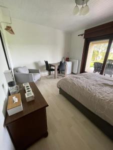a bedroom with a bed and a couch and a table at Elba in Herne +18 photos