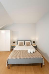 a bedroom with a large bed with two tables at Douro Villa 4 - Best View in Town in Bandeira