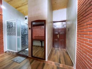 a hallway with a door and a brick wall at Ella Tea Heaven Villa in Ella +161 photos