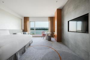 a hotel room with a large bed and a flat screen tv at InterContinental Suzhou Hotel by IHG in Suzhou