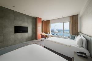 a hotel room with two beds and a television at InterContinental Suzhou Hotel by IHG in Suzhou
