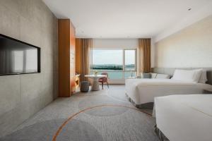 a hotel room with a bed and a television at InterContinental Suzhou Hotel by IHG in Suzhou