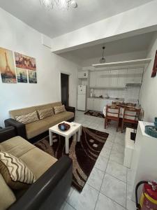 a living room with a couch and a table at Δεσκάτη-Deskati apartment in Deskáti