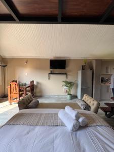 a bedroom with a large bed with towels on it at Leanie's Place in Clarens