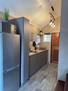 a kitchen with a refrigerator and a sink at Leanie's Place in Clarens