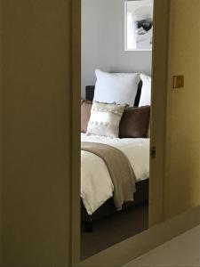 a doorway to a bedroom with a bed with pillows at Urban Oasis in Toronto