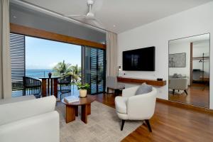 a living room with a view of the ocean at Nyne Hotels Anuprit - Bentota in Bentota +13 photos