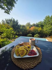 a plate of food on a table with a cup of coffee at Chez Valentine in Anneyron