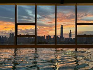 a swimming pool with a view of a city skyline at Wuhan Marriott Hotel Wuchang in Wuhan +211 photos