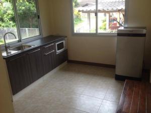 a kitchen with a sink and a microwave at JS HOUSE Singha Park Chiang Rai in Ban Mae Kon +14 photos