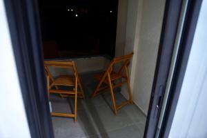 a table and a chair on a balcony at night at Résidence Sana in Mahdia