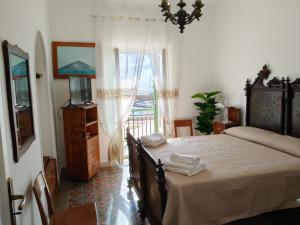 a bedroom with a bed and a window with a view at Eos Lipari in Lipari