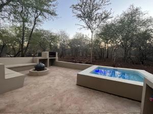 a hot tub on a patio with trees in the background at Erdvarkie at Kruger, Marloth Park in Marloth Park