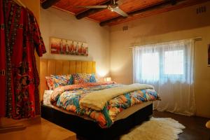 a bedroom with a bed and a window at Hluhluwe Homestead in Hluhluwe +35 photos