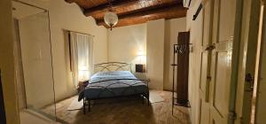 a bedroom with a bed and a glass door at Villa Colli in Picciano +50 photos