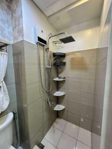 a shower in a bathroom with a toilet and a sink at Blisshaven SHORE 2 B03-14100 in Sampong