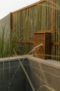 a water hose is connected to a wooden fence at Jeju Leval Homme The Gwangnyeong Forest in Haean