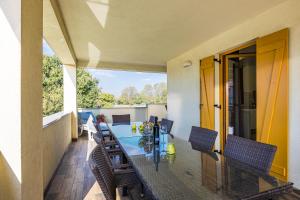 a dining room with a table and chairs on a balcony at Villa Palatium I in Fažana