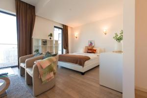 a hotel room with a bed and a couch at Premium Studio Apartment in Herastrau with City View in Herăstrău