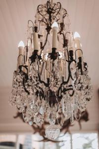 a chandelier hanging from the ceiling in a room at Lindsay House Guest House in Armidale