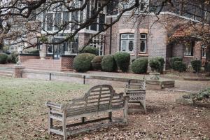 a park bench sitting in front of a building at Lindsay House Guest House in Armidale