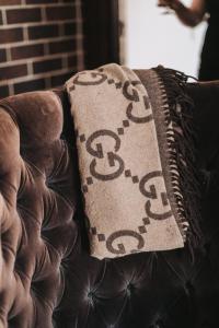 a brown couch with a throw pillow on it at Lindsay House Guest House in Armidale +14 photos