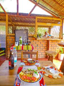 a table with plates of food on top of it at Le Relais de Djangoa in Djangoa