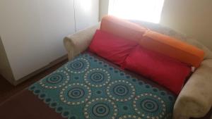 a couch with two pillows on it in a room at 2 Bed, King XL Bed, Dining&Office Space in Heathfield