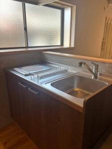 a kitchen with a sink and a window at P-Stay宮島中西町 in Hatsukaichi