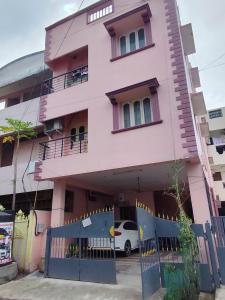 un edificio rosa con una valla delante en Rithu Homestay, en Chennai 11 fotos más