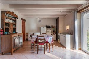 a kitchen with a table and chairs in a room at Le Petit Montparnasse - Montrichard in Montrichard