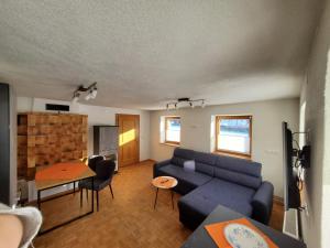 a living room with a couch and a table at Rosa s Ferienhaus in Grän