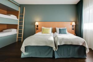a bedroom with a bed with two bunk beds at Quality Hotel Globe in Stockholm +52 photos