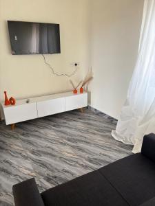 a living room with a television on a wall at Kasoa Stay in Kasoa +21 photos