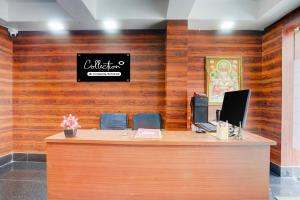 an office with a desk with a sign on the wall at Super Collection O Biswa Bangla Kolkata Formerly Dream Palace in Kolkata