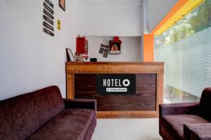 a living room with a couch and a fireplace at Hotel O Nepali Mandir Bus Terminal Formerly Hotel Aaghnya in Guwahati