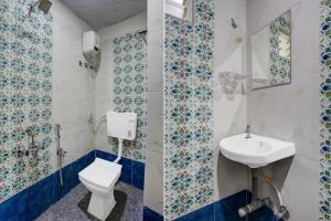 a bathroom with a toilet and a sink at Collection O Nashik Central Railway Junction Formerly Dream Heritage Inn in Nashik