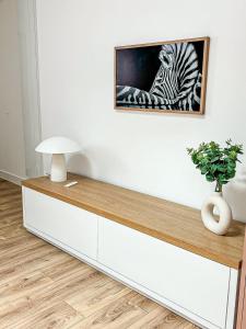 Una mesa con una imagen de una cebra en una pared. en La Cahute Rochelaise - Cosy dans le centre-ville à 5 min du port, en La Rochelle 11 fotos más