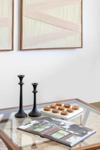 a glass table with a tray of donuts on it at Frank Porter - Parkside 2, Emaar South in Ghantoot