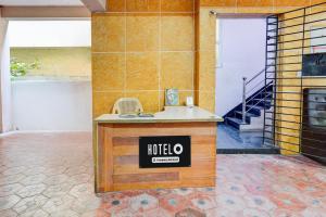a hotel sign on a counter in a room at Hotel O Ashok Nagar Metro Station Chennai Formerly G Cloud in Chennai