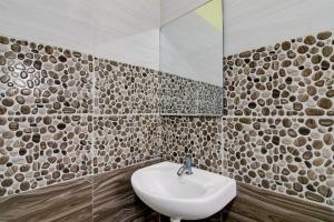 a bathroom with a sink and a mirror at Super Hotel O Birsa Athletics Stadium Formerly De Anmol Suites in Nāmkom