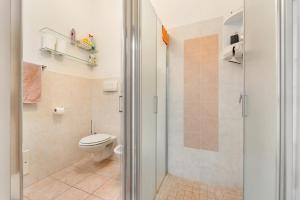 a bathroom with a toilet and a shower stall at Casa Susanna in Calasetta +22 photos