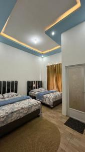 a bedroom with two beds and a fireplace at Rahayu Cabin Villa in Dieng +16 photos