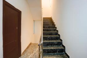 a staircase leading up to a door in a building at Hotel O Kogilu Bus Terminal Formerly Peaceful Stay in Yelahanka