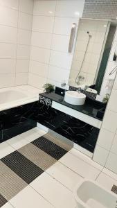 a bathroom with a sink and a tub and a toilet at Elegant apartment overlooking the sea in Jeddah +16 photos