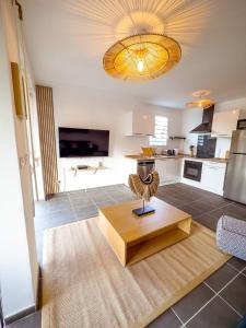 a living room with a table and a kitchen at Evasion tropical in Les Trois-Îlets