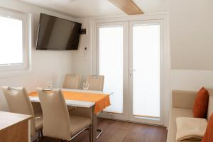 a dining room with a table and chairs at Floating House Marina in Portorož